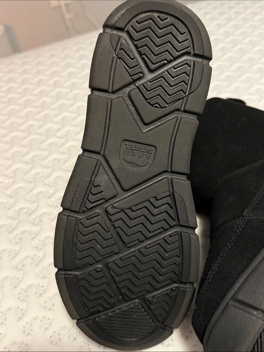 The image shows a pair of black SOREL Women's Explorer III Slip-On waterproof